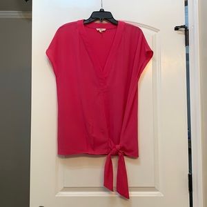 Large, bright pink, V neck blouse.